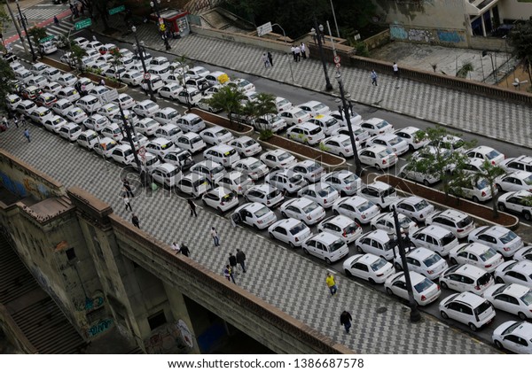 Sao Paulo, SP / Brazil - Sept 9. 2016: Taxi drivers
block a street to protest the Uber ride sharing service. Cab
drivers complain Uber is unfair competition because its drivers
don't have to pay fees.