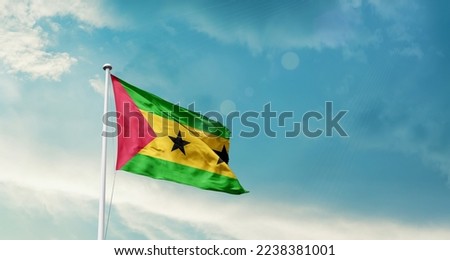 Sao Tome and Principe national flag waving in beautiful sky.