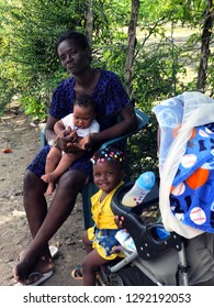 Saona, Dominicana, December 2018. Dominican Family: A Mother And Two Small Dark-skinned Dirty Children In A Fishing Village.