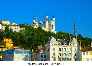 Saone river embankment with Basilica of Notre-Dame de Fourviere on hill, Lyon, France.