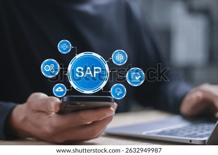 SAP enterprise software concept. Data processing systems, applications and products. Businessman working with SAP software on computer laptop and smartphone.