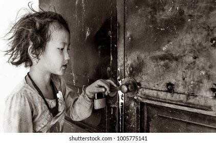 SAPA VIETNAM MARCH 2015: Little Girl Holding The Door Of Closed Classroom Waiting For Teacher To Open, Sapa, Vietnam