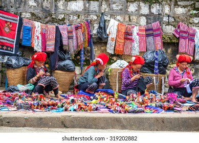 SAPA, VIETNAM - September 10,2015 : Hmong woman on the main street of Sapa on September 10,2015 in Sapa, Vietnam. Hmong people are costumes and ornate silver jewellery to sell handmade goods.