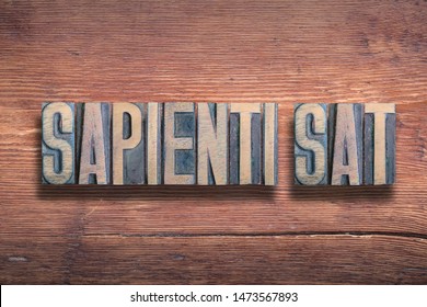 sapienti sat ancient Latin saying meaning - enough for the wise, or common sense, combined on vintage varnished wooden surface - Shutterstock ID 1473567893