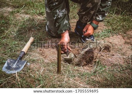 Sapper neutralizing the mine. Minesweeper is preparing for a mine detonator. Outdoors