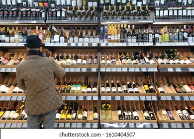 SAPPORO, JAPAN - 23 DEC 2019 : Rear View Of A Senior People Looking At Wine In Grocery Store. Wine Is An Alcoholic Drink Typically Made From Fermented Grapes.