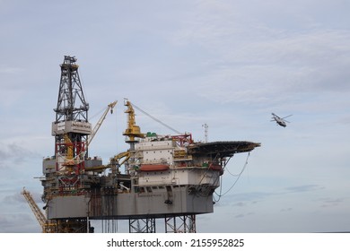 Sapudi, May 2022. Chopper landing on the helideck of Oil rig, which functions for offshore drilling on offshore oil drilling platforms. for oil and gas exploration on the seabed. helicopter on helipad