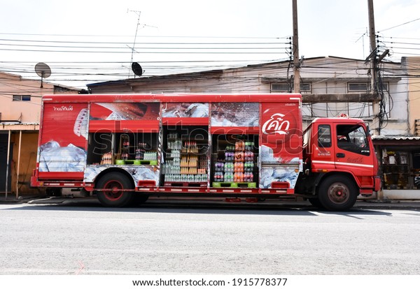 Saraburi - Thailand, Feb 13,2021: A truck with\
a box. Coca-cola. Coca-Cola or Coke is a carbonated beverage\
produced by Coca-Cola.