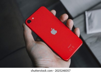 Sarajevo, Bosnia And Herzegovina - 06 09 2021: Male Hand Holding IPhone SE 2020 In Product Red Color Variant, Back Side Facing Up.