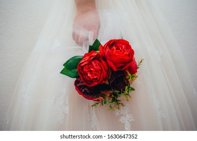 Sarajevo / Bosnia And Herzegovina - December 29th 2019:

The Bride Holds The Bouquet.
Red Roses.