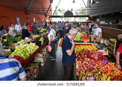 Sarajevo, Bosnia And Herzegovina, June 2022: People Buying Fresh Vegetable And Fruit In Market. Group Of People Shopping. Customers Buying Food.