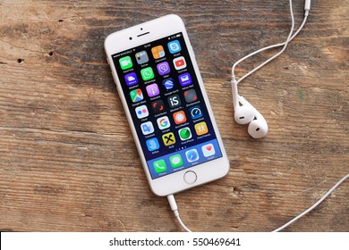 SARAJEVO , BOSNIA AND HERZEGOVINA - MARCH 27 , 2016 : New Gray IPhone 6 With Colorful Screen On The Wooden Table. IPhone 6 Was Created And Developed By The Apple Inc.