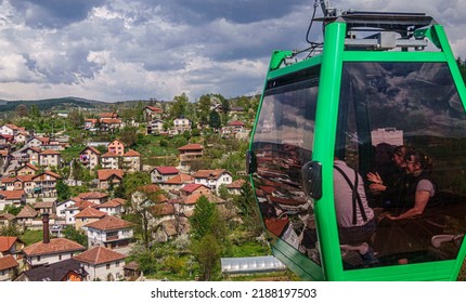 Sarajevo, Bosnia - May 2, 2022 - Woman looks out over Sarajevo from cable car