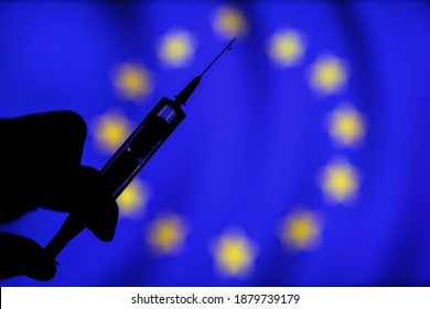 Sarajevo,FBiH,Bosnia And Herzegovina - 21.12.2020: Covid 19 Vaccine Syringe Needle Isolated And European Union Flag Blurred In Background