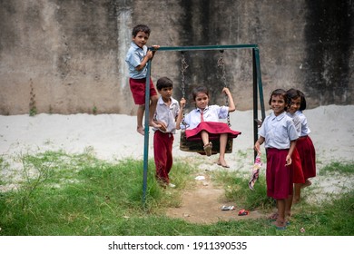 Saran, Bihar, India,  25th July 2013: A View Of Private School In Saran, Kids In School Uniform  Playing On Swings.