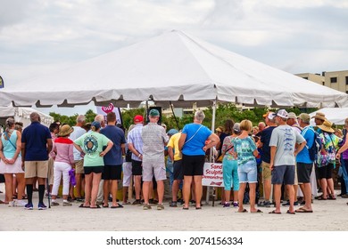 SARASOTA, FL, USA - NOV. 12, 2021:  Attendees Outside A Tent Watch A Live Demonstration Of Sand Sculpting At Siesta Key Crystal Classic, An International Sand Sculpting Festival On Siesta Key Beach.