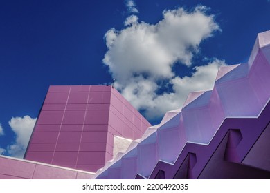 Sarasota, FL, US-May 30, 2022: Abstract View Of The Van Wezel Performing Arts Center Which Is A Pastel Purple Against A Brilliant Blue Sky With Puffy Clouds.