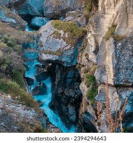 The Saraswati River near Mana, the last village of Uttarakhand, flows gently through the pristine Himalayan terrain. Enveloped by lush greenery, the river adds to the idyllic charm of this Village. - Powered by Shutterstock