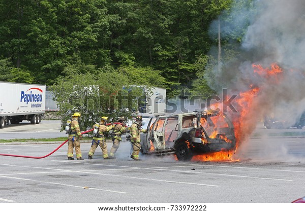 SARATOGA SPRINGS, NEW YORK - JUNE 7 2017:
SUV catches fire & burns while parked at highway rest stop
along Highway 87. Firefighters douse
flames