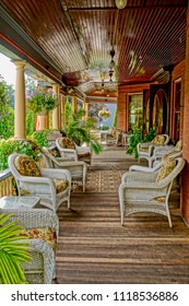 Saratoga Springs, New York/USA- June 22, 2018: A Vertical High Definition Image Of The Front Porch And Wicker Furniture Of A Historic Iconic Queen Anne Victorian Mansion Turned Into A Hotel. 