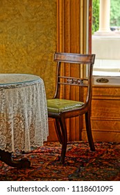 Saratoga Springs, New York/USA- June 22, 2018: A Vertical High Definition  Image Of A Table And Chair In The Parlor Of A Historic Iconic Queen Anne Victorian Mansion Turned Into A Hotel.