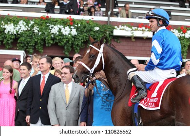 SARATOGA SPRINGS, NY - JULY 28: Jockey Ramon Dominguez Aboard Alpha In The Winners Circle After Winning The Jim Dandy Stakes On July 28, 2012 Saratoga Springs, New York