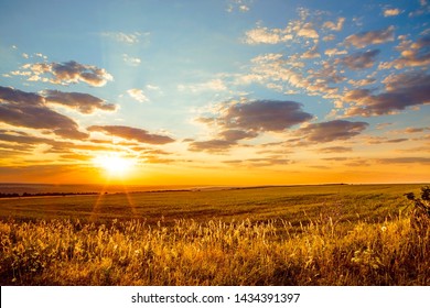 Saratov region, travel, landscape and nature of Russia. Yellow golden orange dramatic dawn at dawn or dusk over endless fields, hills, meadows. The sun rises in the morning above the horizon - Shutterstock ID 1434391397