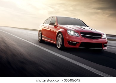 Saratov, Russia - August 24, 2014: Red Sportcar Mercedes-Benz C63 AMG Fast Speed Driving On The Asphalt Road At Daytime