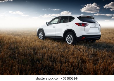 Saratov, Russia - August 30, 2014: White modern car Mazda CX-5 stay on yellow field at autumn