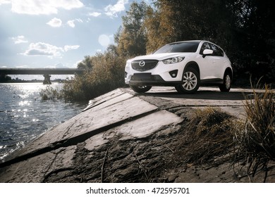 Saratov, Russia - August 30, 2014: Car Mazda CX-5 stand on asphalt countryside road near river at daytime