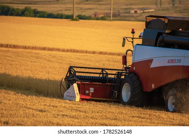 Saratov, RUSSIA - July 10, 2020: Combine Harvester At Work Harvesting A Field Of Wheat . High Quality Photo