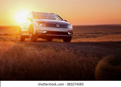 Saratov, Russia - June 02, 2014: Grey car Volkswagen Passat stay on dirt road at sunset