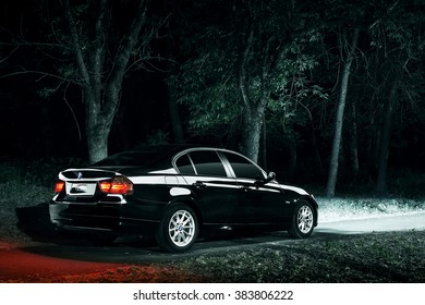 Saratov, Russia - June 12, 2015: Black Car BMW E90 Stay In Darkness Forest At Night