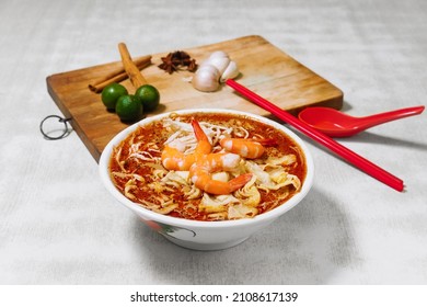 Sarawak Laksa With Raw Garlic, Lemon. A Popular Food In Malaysia Top View