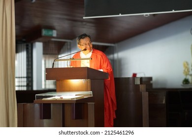 Sarawak, Malaysia – August 31, 2013: Portrait Of A Pastor With A Church Red Costume  During A Sermon. The Preacher Delivers A Speech In A Church.