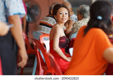 Sarawak, Malaysia – December 30 2012: The Photo Showing A Portrait Of An Asian Young Beautiful Bride Greeting Her Guest With A Polite Smile While Sitting On The Chair.                      