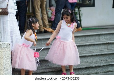 Sarawak, Malaysia – March 31 2013:The Photo Showing Portrait Of Two Adorable Playful Little Girls In Same Dress Playing Together At The Park.