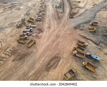Sarawak, Malaysia – September 10, 2021:The photo showing an aerial view of heavy hauling and machinery equipment parking at construction site after finished earthwork site clearing.