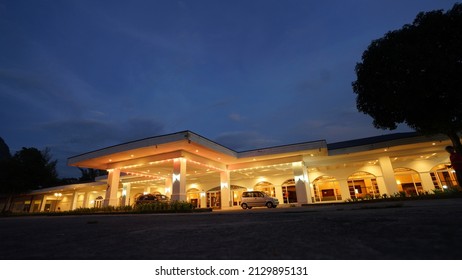 Sarawak, Malaysia – September 30, 2013: The photo showing warm yellow light shines out of the windows and the ajar front door of a suburban house in the late evening twilight.
