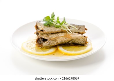 Sardines with slice lemon on a white plate 