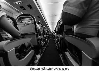 Sardinia, Italy, May 2020. Dramatic Interior View Of International Flight During Turbulence. Traveling During Covid-19 Pandemic, Safety Protocol, Black And White Perspective Shot.  Seasonal Holidays.