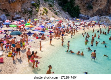 Sardinia/Italy - August 26, 2019 - Crowd Of Tourists On Cala Mariolu Beach In The Golf Of Orosei