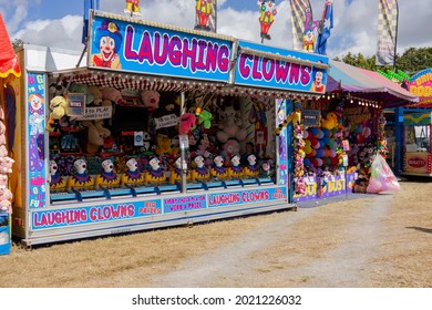 Sarina, Queensland, Australia - August 2021; Laughing Clowns Booth With Lots Of Prizes At A Funfair Before The Gates Open.