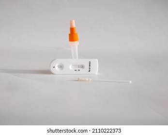 SARS-CoV-2 Antigen Rapid Test (Nasal Swab) For Self Testing With Used Sterile Swab And Test Cassette With Negative Result Isolated On White In Bright Sunlight. COVID-19 Ag.