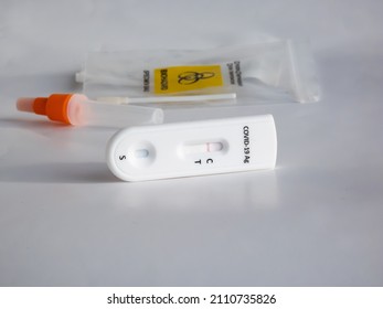 SARS-CoV-2 Antigen Rapid Test (Nasal Swab) For Self Testing With Use Sterile Swab And Test Cassette With Negative Result Isolated On White In Bright Sunlight. COVID-19 Ag.