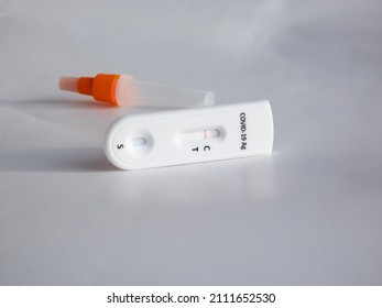 SARS-CoV-2 Antigen Rapid Test (Nasal Swab) For Self Testing With Use Sterile Swab And Test Cassette With Negative Result Isolated On White In Bright Sunlight. COVID-19 Ag.