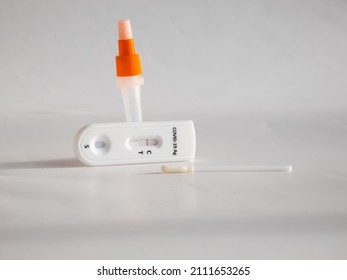 SARS-CoV-2 Antigen Rapid Test (Nasal Swab) For Self Testing With Used Sterile Swab And Test Cassette With Negative Result Isolated On White In Bright Sunlight. COVID-19 Ag.