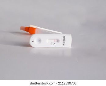 SARS-CoV-2 Antigen Rapid Test (Nasal Swab) For Self Testing With Use Sterile Swab And Test Cassette With Negative Result Isolated On White In Bright Sunlight. COVID-19 Ag.