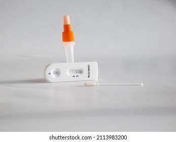 SARS-CoV-2 Antigen Rapid Test (Nasal Swab) For Self Testing With Used Sterile Swab And Test Cassette With Negative Result Isolated On White In Bright Sunlight. COVID-19 Ag.