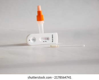 SARS-CoV-2 Antigen Rapid Test (Nasal Swab) for self testing with used sterile swab and test cassette with Negative result isolated on white in bright sunlight. COVID-19 Ag.